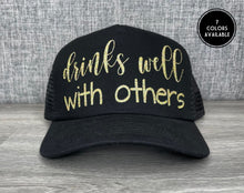 Load image into Gallery viewer, Drinks well with others Trucker Hat